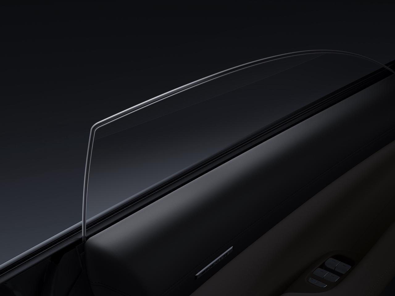 The interior side of the car door, with details of black leather and glass windows, against a dark background.