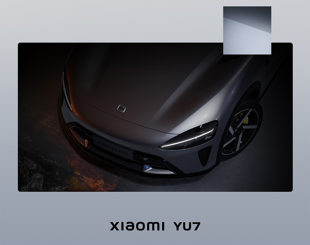 A gray Xiaomi YU7 electric vehicle viewed from above appears smooth in a dimly lit environment, with the brand logo on the front.