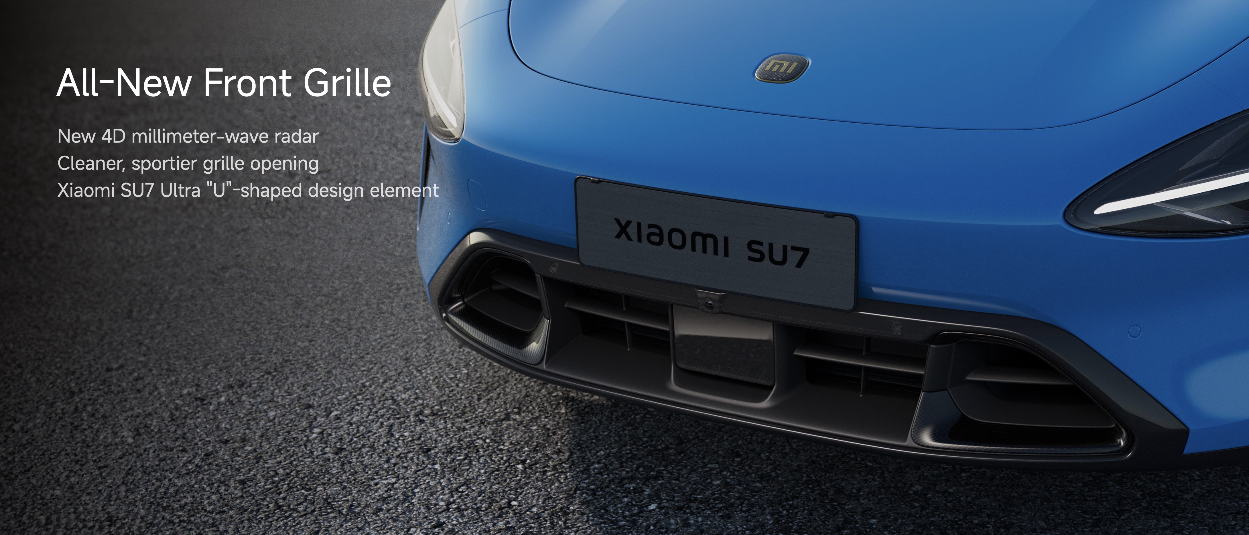 The image features the front grille of the Xiaomi SU7, highlighting its new design elements. It includes a cleaner, sportier grille opening and a 4D millimeter-wave radar. The design features a "U"-shaped element, enhancing its aesthetic appeal. The vehicle is shown in a sleek blue color.