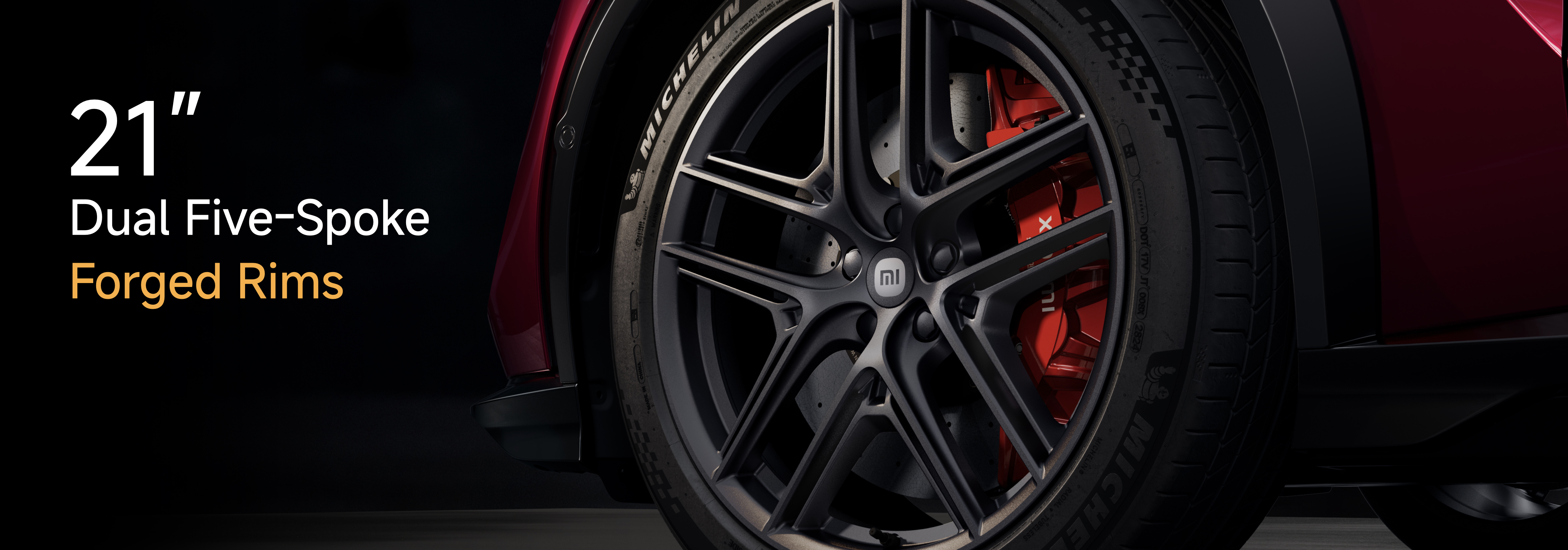 A 21-inch dual five-spoke forged wheel is displayed, featuring red brake calipers, with an overall modern and sporty appearance. The background is dark, highlighting the design details of the wheel.