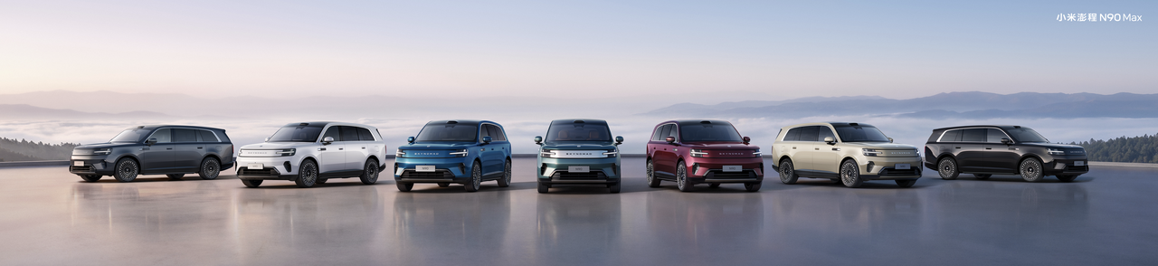 A variety of SUVs are neatly arranged outdoors, with mountains and mist in the background, showcasing the diversity and beauty of modern automotive design. The body colors include white, gray, blue, green, red, and black.