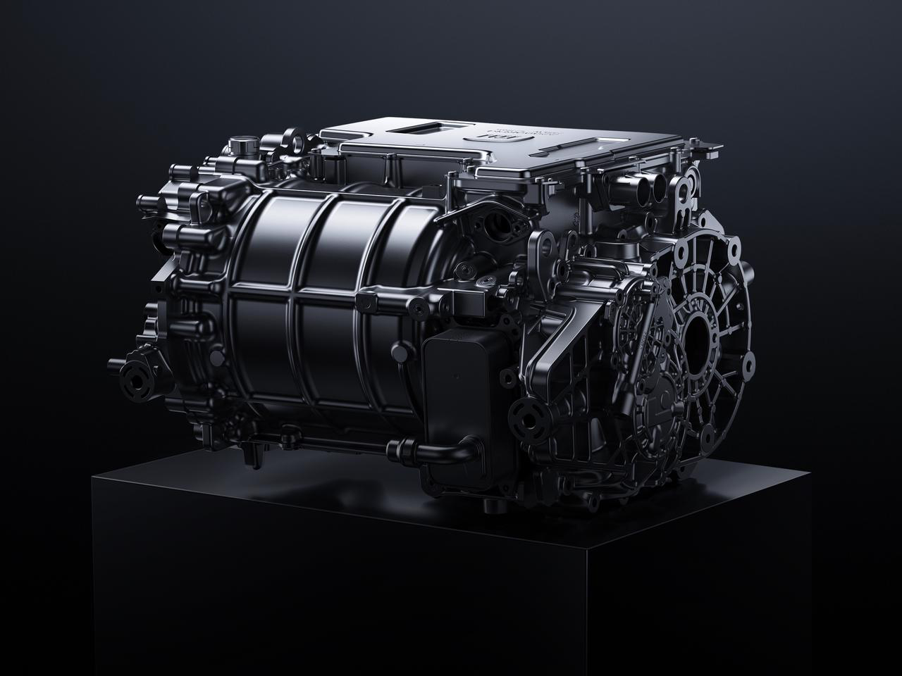 A black car engine model is placed on a black base, with a dark background.
