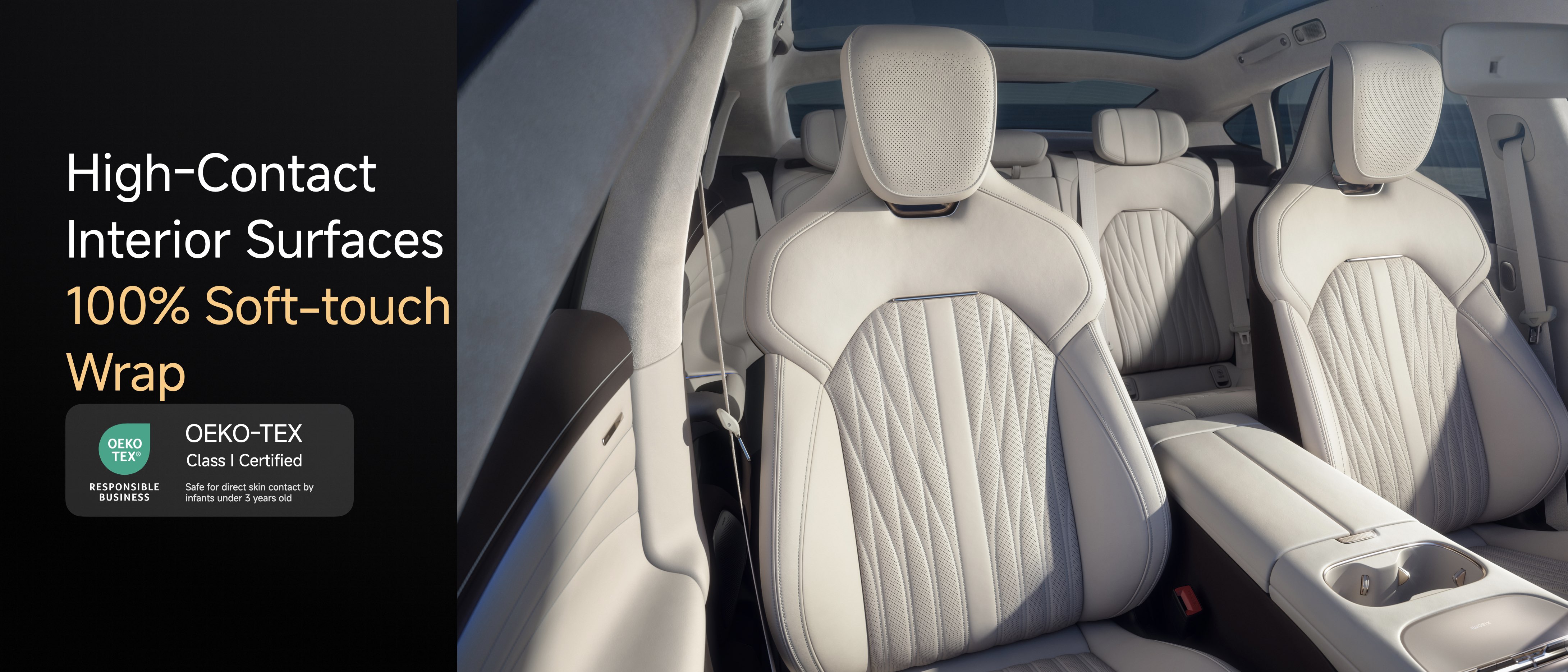 Interior of a vehicle featuring high-contact surfaces with a soft-touch wrap. The seats are designed with a sleek, modern look, showcasing a light color scheme and detailed stitching. A certification logo indicates the material is safe for contact with infants under three years old.